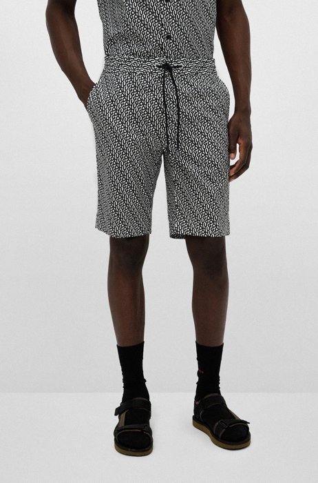 Slim-fit shorts in all-over logo-print cotton, Black Patterned