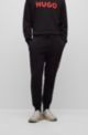 Pantaloni della tuta in french terry con fondo gamba elastico e logo a contrasto, Nero