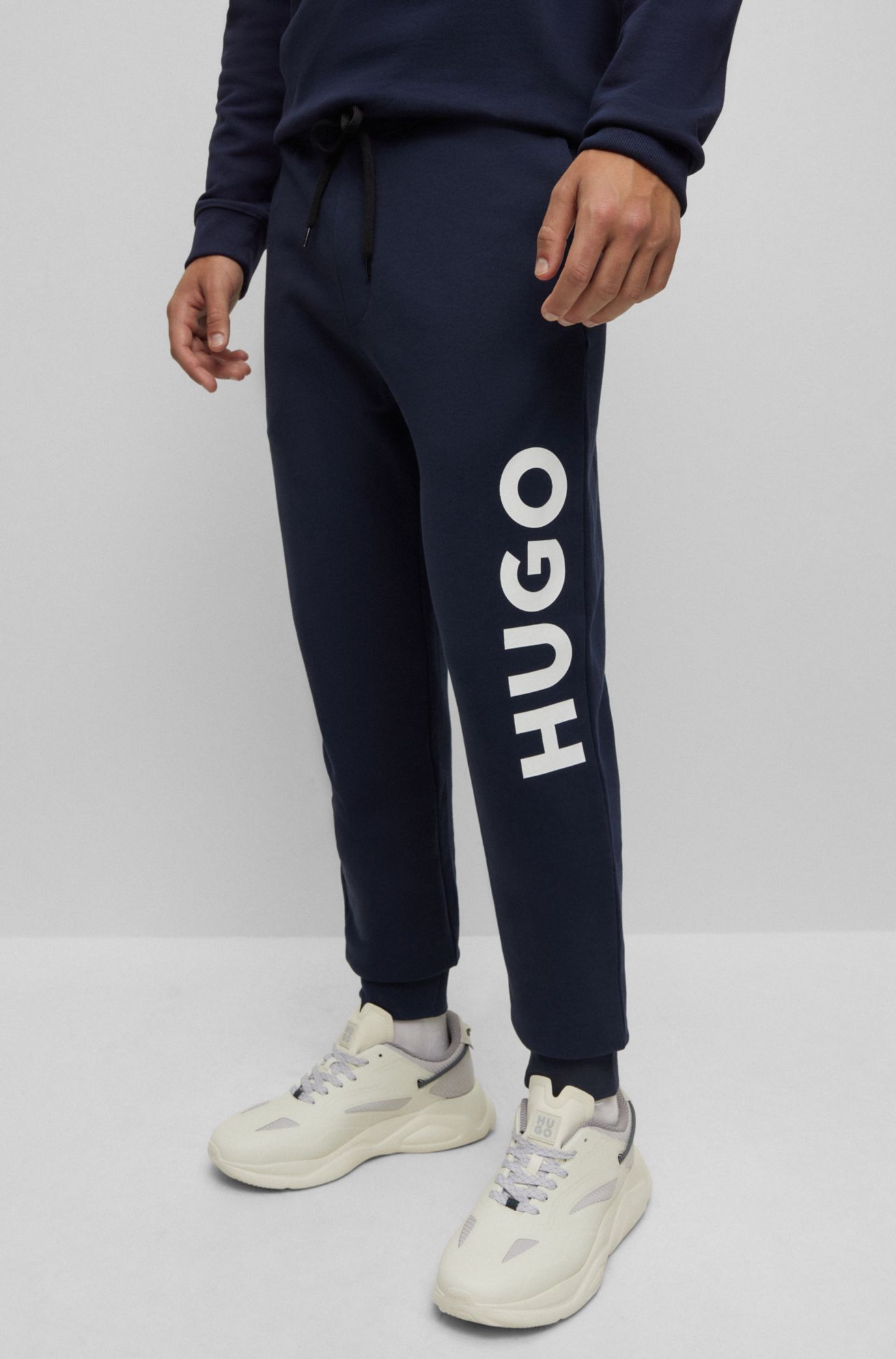 HUGO - Cotton-terry tracksuit bottoms with red logo label