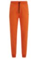 Organic-cotton tracksuit bottoms with logo tape, Dark Orange