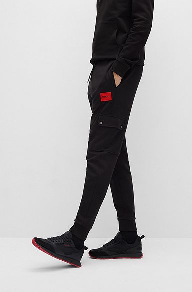 Relaxed-fit tracksuit bottoms with red logo label, Black