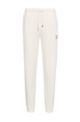 Cotton-terry tracksuit bottoms with logo detail, White
