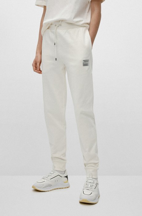 Cotton-terry tracksuit bottoms with logo detail, White