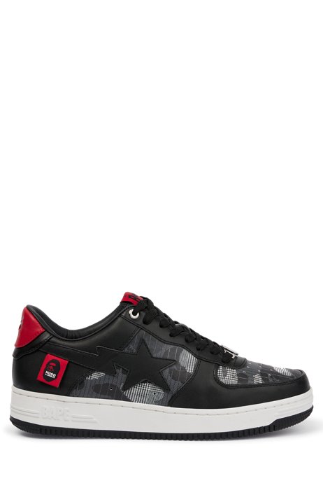 Low-top trainers with leather uppers and collaborative branding, Black
