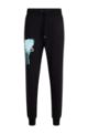 Relaxed-fit tracksuit bottoms with graffiti artwork, Black