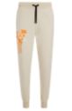 Relaxed-fit tracksuit bottoms with graffiti artwork, Light Beige