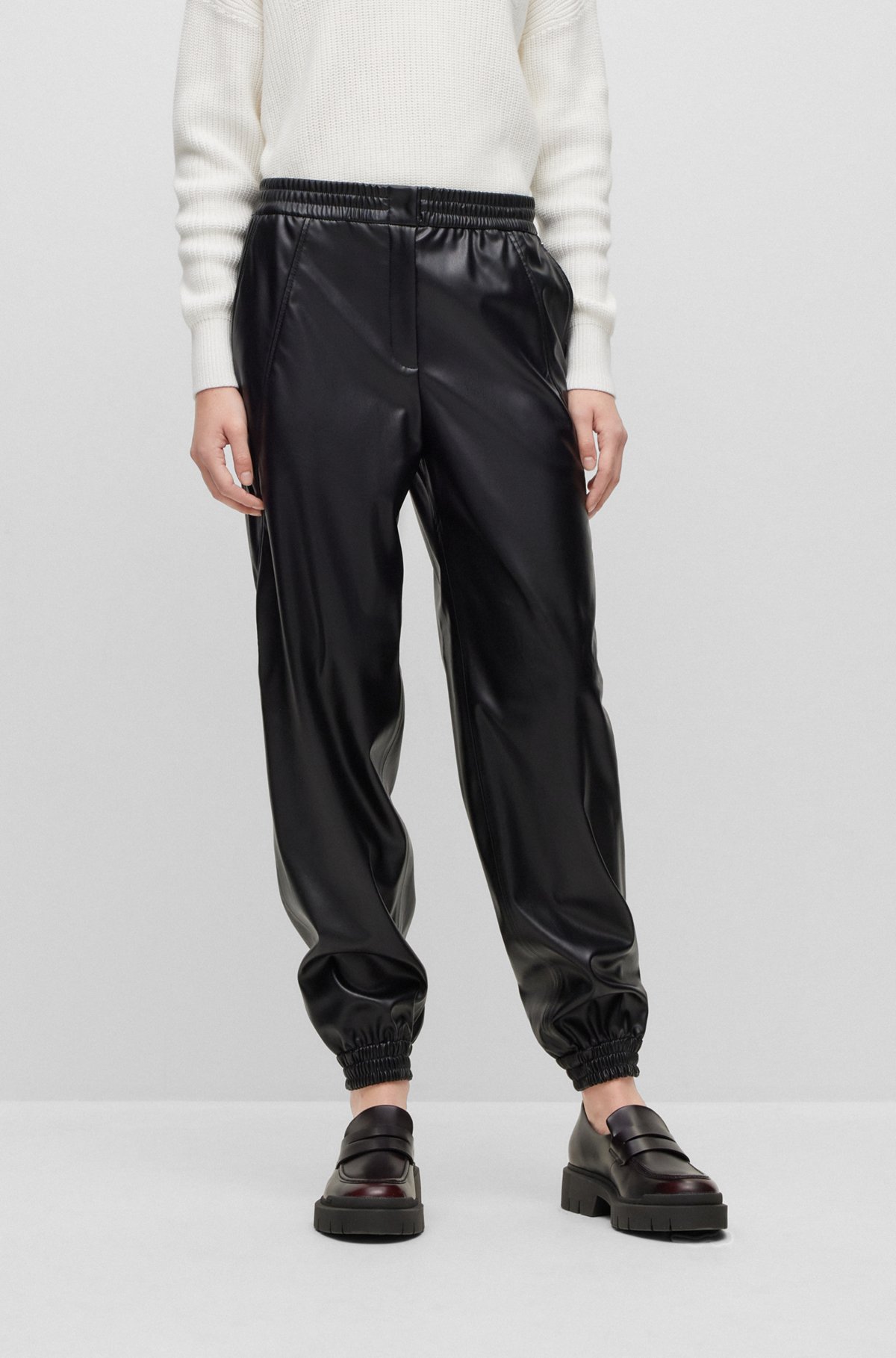 Cuffed tapered-fit trousers in faux leather, Black