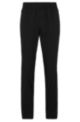 Water-repellent tracksuit bottoms with zipped hems, Black
