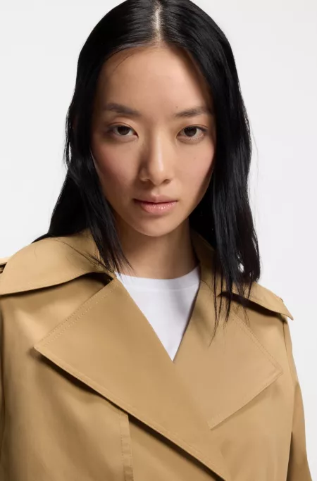 Double-breasted trench coat with buckled belt