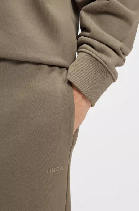 Cuffed tracksuit bottoms in cotton terry with logo print