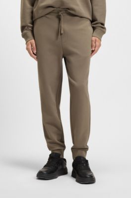 Bas de surv&ecirc;tement en molleton de coton avec logo imprim&eacute; et bas de jambes resserr&eacute;s, Marron