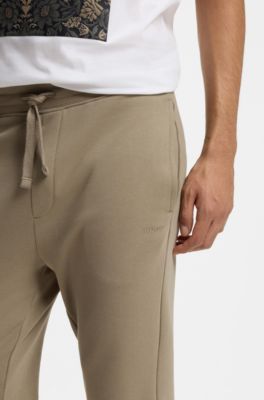 Cuffed tracksuit bottoms in cotton terry with logo print, Brown