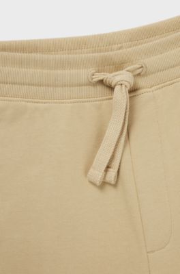 Jogginghose aus Baumwoll-Terry mit kontrastfarbenem Logo, Hellbeige