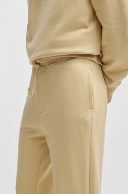 Cuffed tracksuit bottoms in cotton terry with logo print, Light Beige