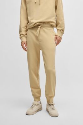 Cuffed tracksuit bottoms in cotton terry with logo print, Light Beige