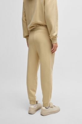 Cuffed tracksuit bottoms in cotton terry with logo print, Light Beige