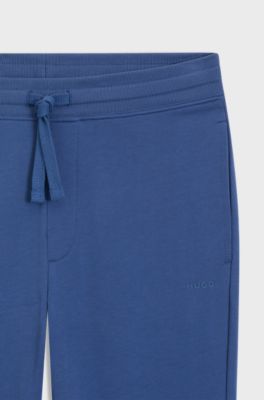 Bas de surv&ecirc;tement en molleton de coton avec logo imprim&eacute; et bas de jambes resserr&eacute;s, Bleu
