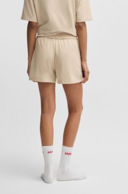 Shorts van stretchmateriaal met logoprint, Lichtbeige