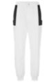 Relaxed-fit tracksuit bottoms with contrast inserts, White