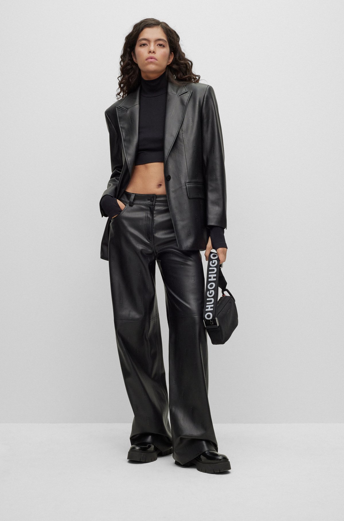 Logo-embossed relaxed-fit trousers in faux leather, Black