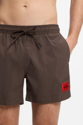 Quick-drying swim shorts with red logo label, Dark Brown