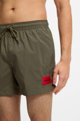 Quick-drying swim shorts with red logo label, Dark Green