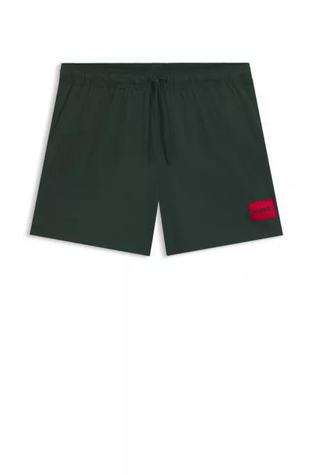 Fully lined swim shorts with red logo label