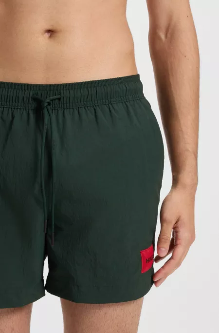 Swim shorts with logo label