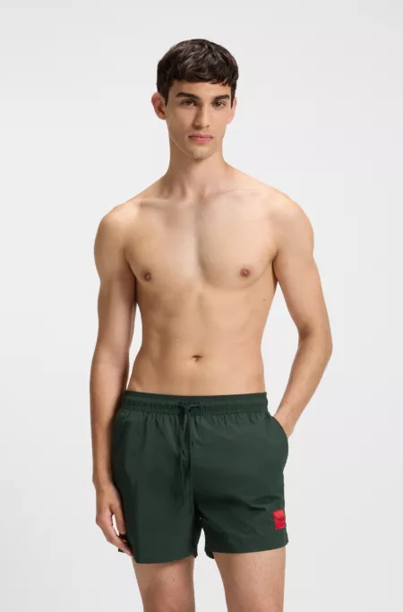 Swim shorts with logo label