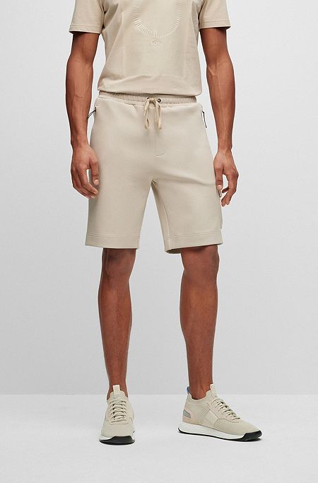 Shorts aus besonders elastischem Baumwoll-Mix mit Reißverschlusstaschen, Beige