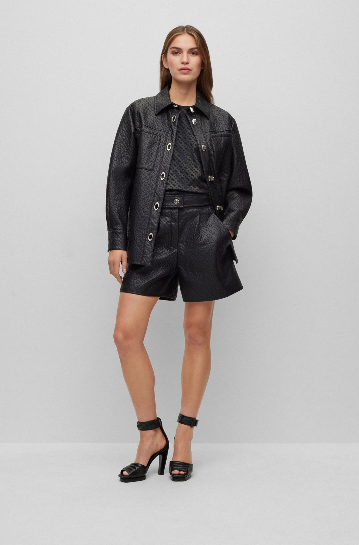 Relaxed-fit shorts in monogram-embossed faux leather, Black