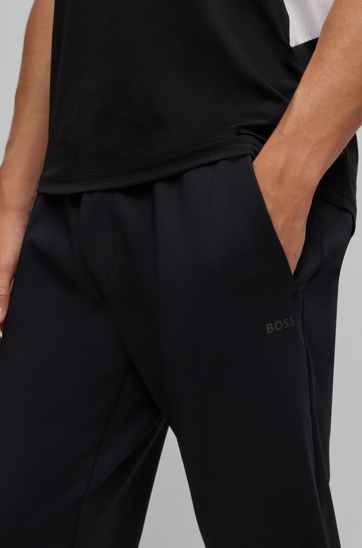 Cuffed tracksuit bottoms in active-stretch fabric, Black