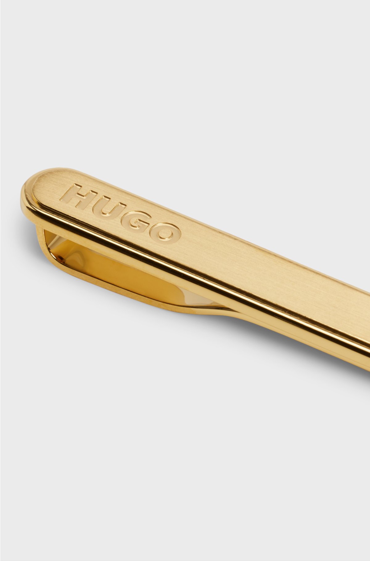 Oval-shaped tie clip with engraved logo, Gold
