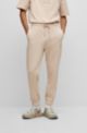 Relaxed-fit cotton-terry tracksuit bottoms with stacked logo, Natural