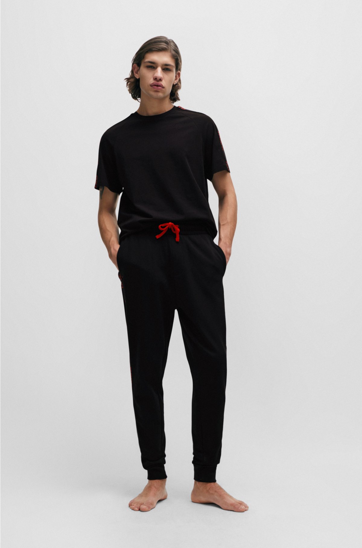 Cuffed tracksuit bottoms in organic cotton with logo tape, Black