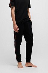 Cuffed tracksuit bottoms in organic cotton with logo tape, Black