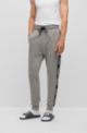 Cuffed tracksuit bottoms in organic cotton with logo tape, Grey