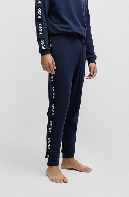 Cuffed tracksuit bottoms in organic cotton with logo tape, Dark Blue