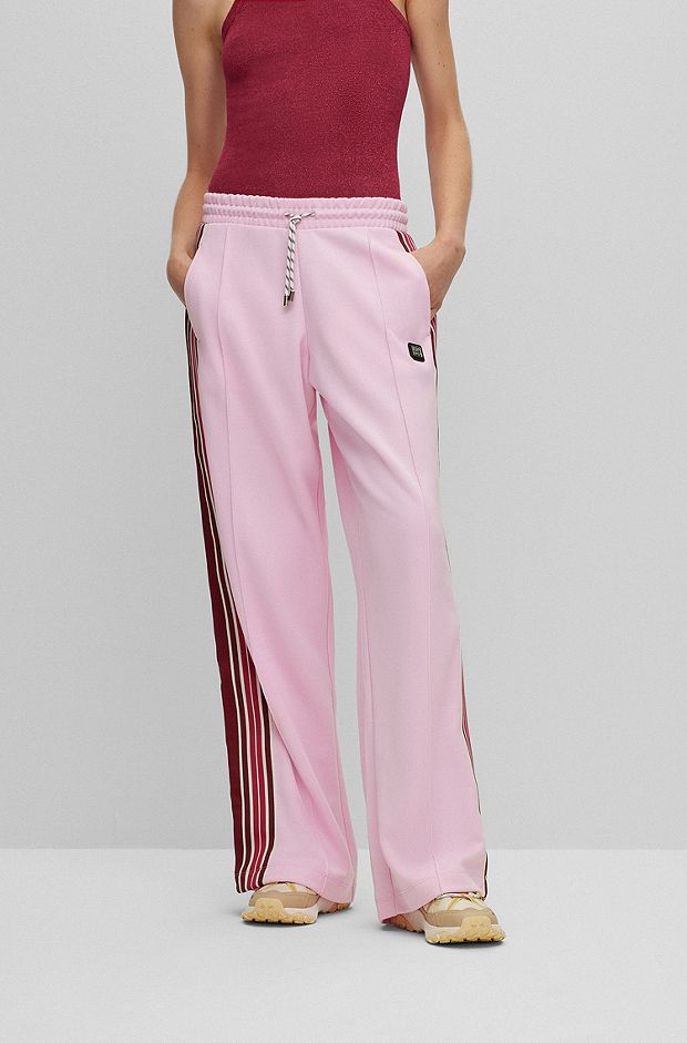 Jersey tracksuit bottoms with logo and tape trims, light pink