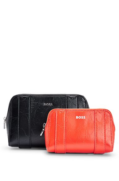 Two textured cosmetic cases with logo details, Black