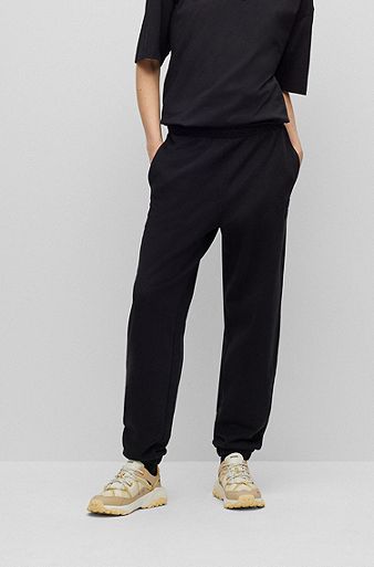 Relaxed-fit tracksuit bottoms with embossed stacked logo, Black