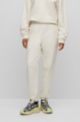 Relaxed-fit tracksuit bottoms with embossed stacked logo, White