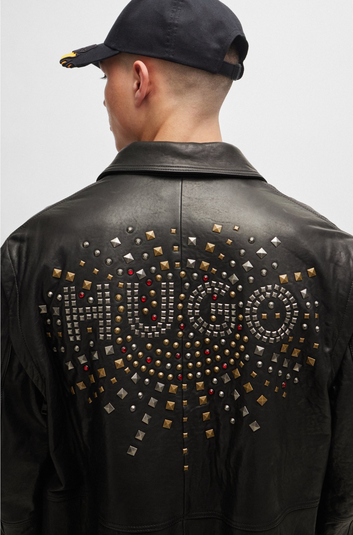 Leather jacket with detachable sleeves and stud artwork, Black