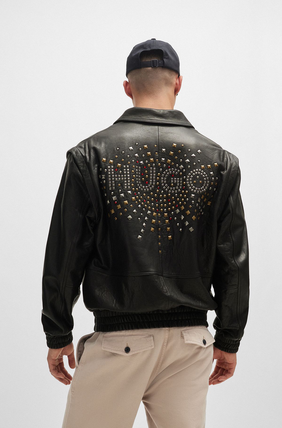 Leather jacket with detachable sleeves and stud artwork, Black