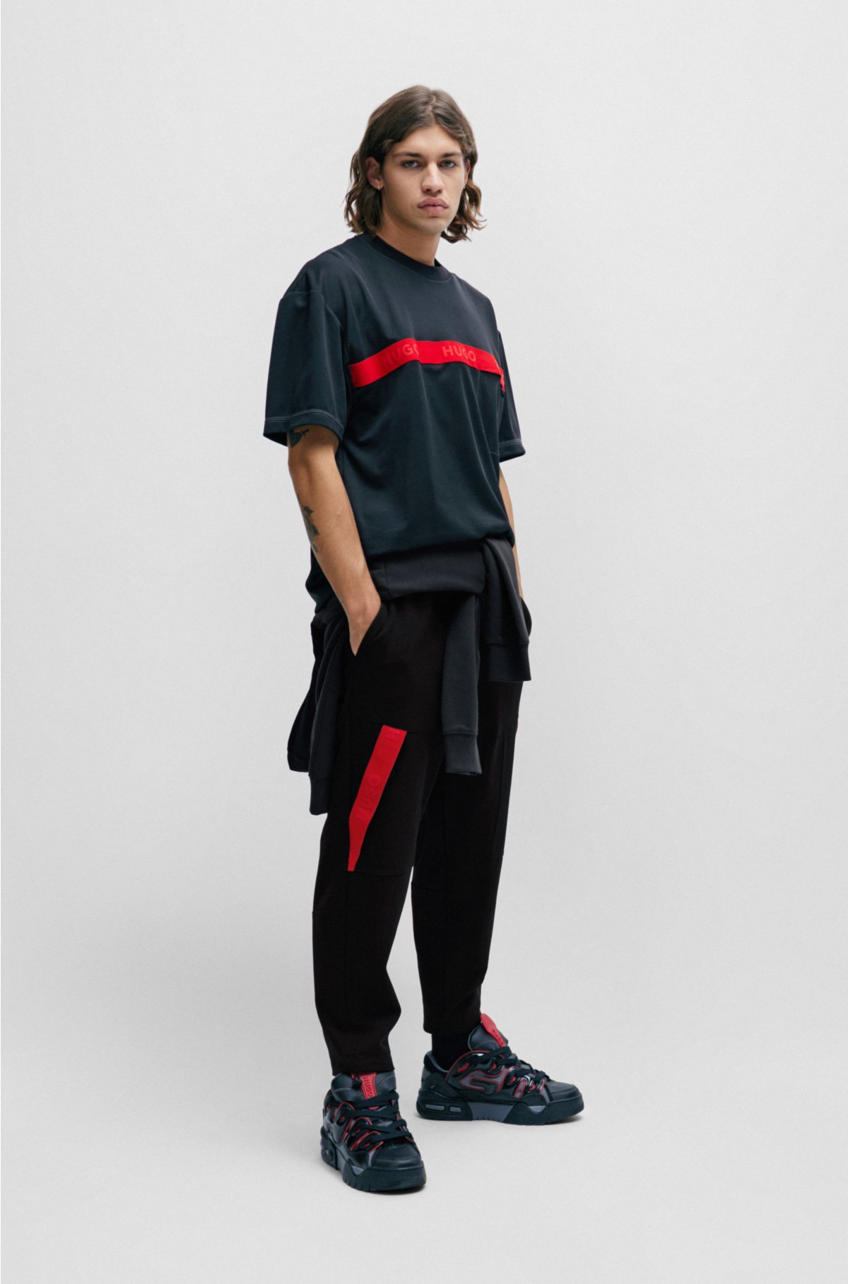 Relaxed-fit tracksuit bottoms with red logo tape, Black