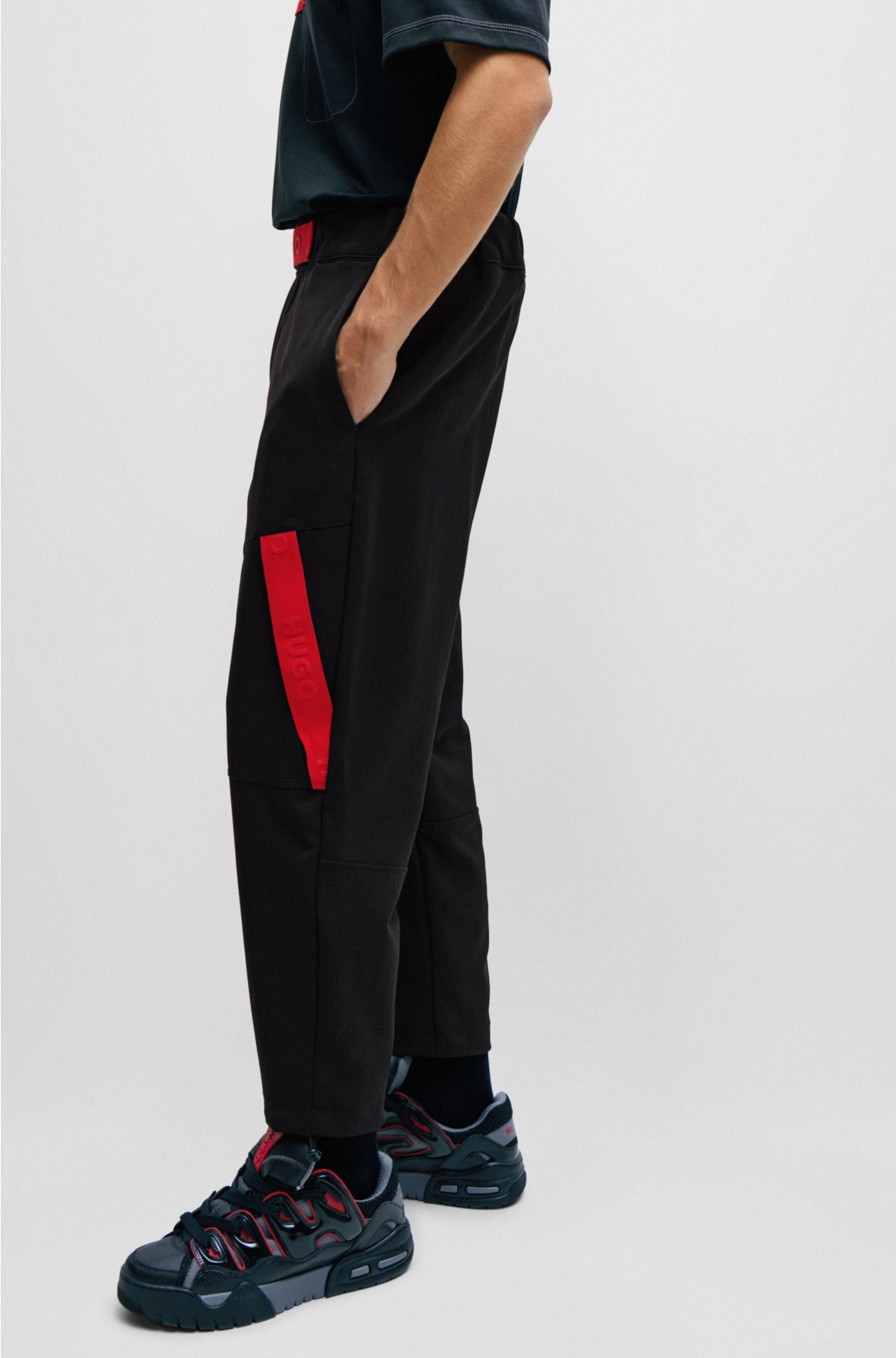 Relaxed-fit tracksuit bottoms with red logo tape, Black