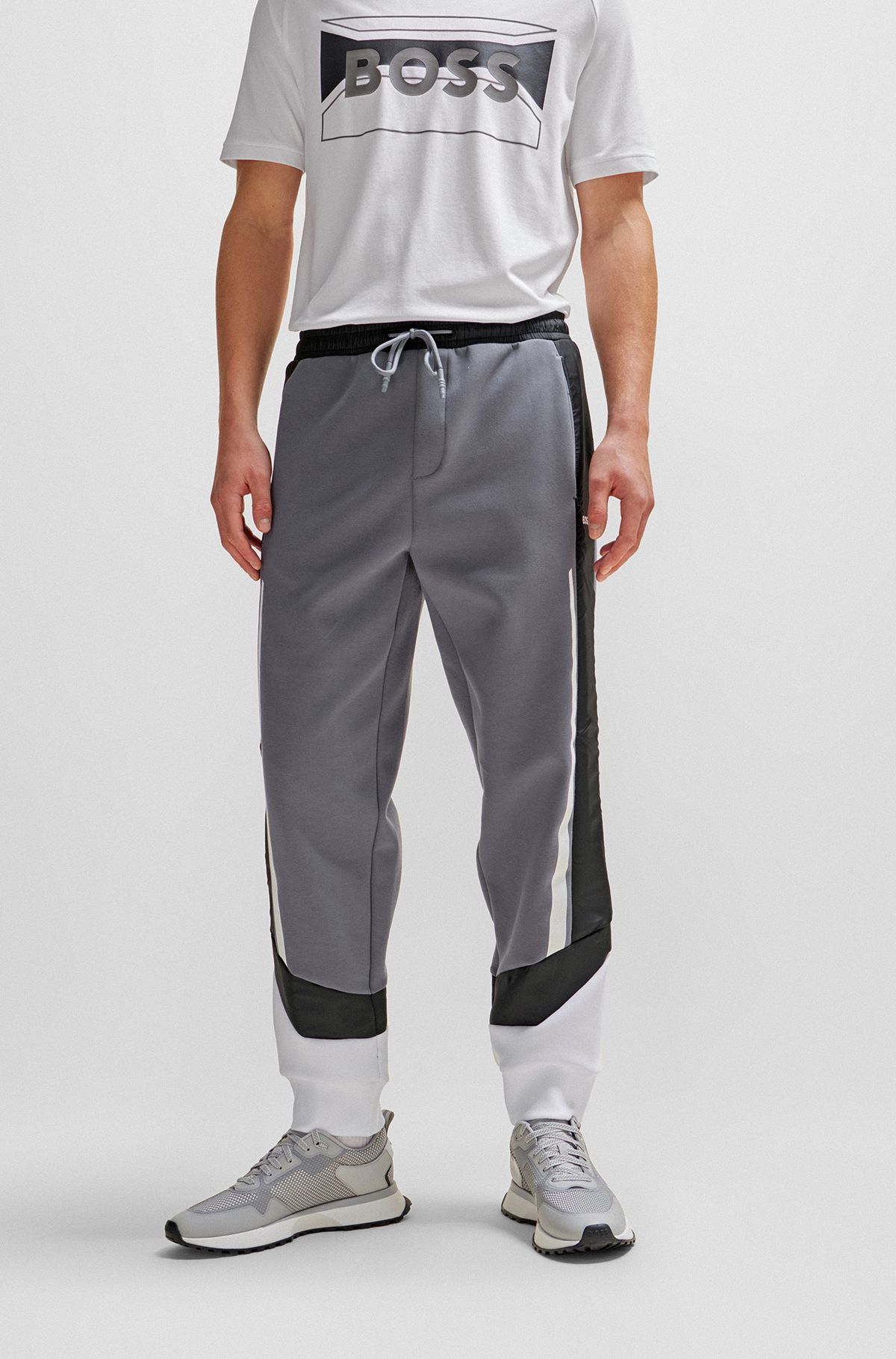 Mixed-material tracksuit bottoms with printed logo, Grey