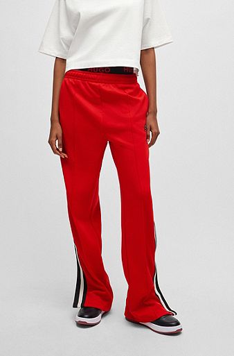 Racing-inspired tracksuit bottoms with striped logo tape, Red