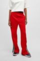 Racing-inspired tracksuit bottoms with striped logo tape, Red