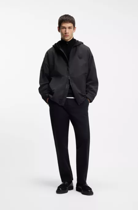 Water-repellent hooded windbreaker with stacked-logo badge